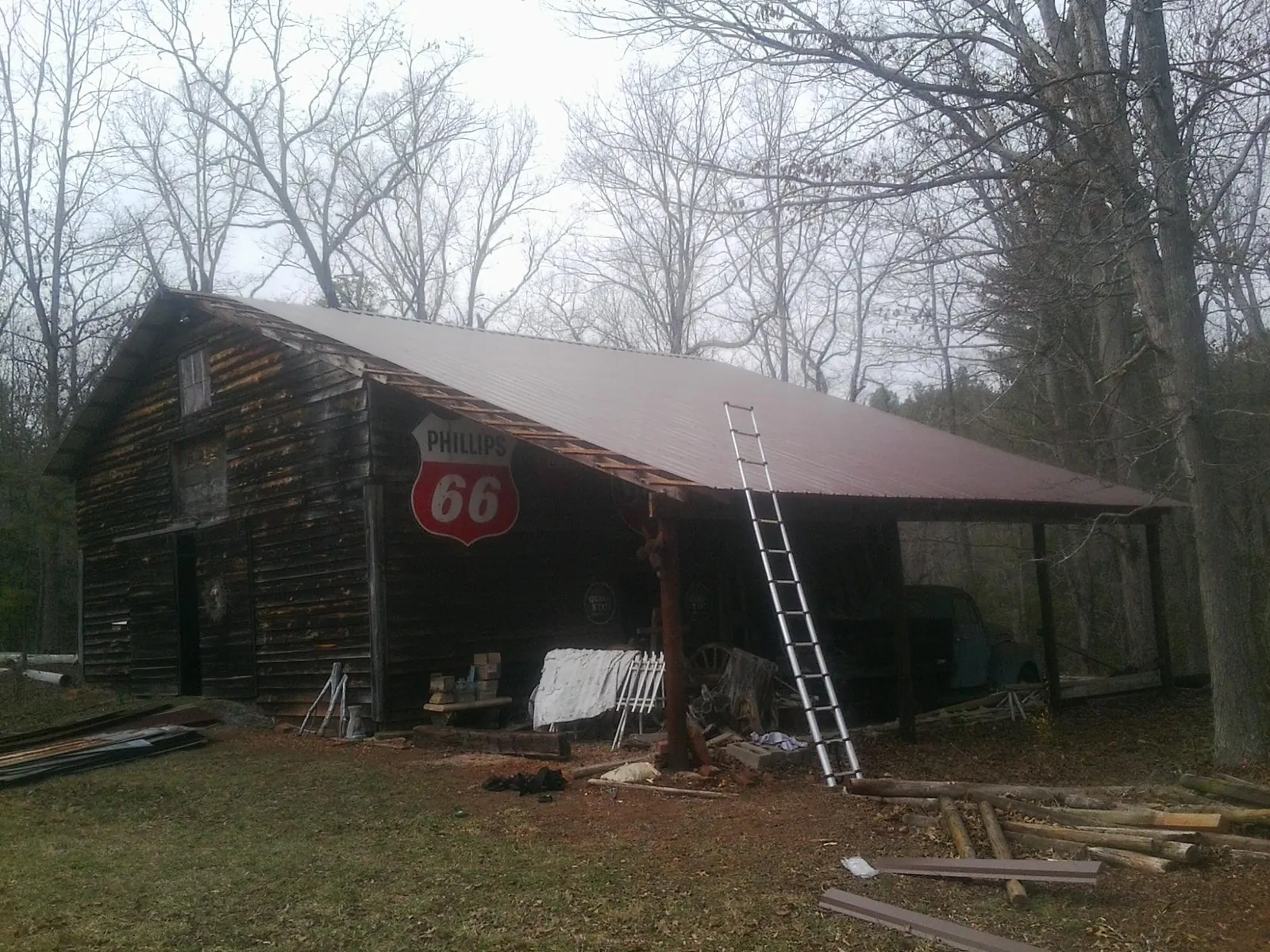 New metal roof on an open sided timber barn with a vintage sign in Campbellsport